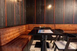 a booth in a restaurant with a table and chairs at Boutique Hotel Metro 900 in Naples +32 photos