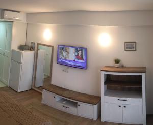 a living room with a tv on a wall at Condo Blaxy Resort Olimp in Olimp