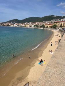 a beach with a group of people in the water at Marina'home in Ajaccio