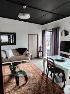 a living room with a table and a couch at Prosper Stud Guest House in Robertson