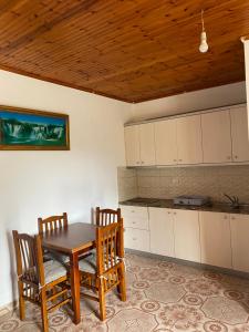 a kitchen with a table and chairs in a room at Vila Demiraj Ksamil Sarande in Ksamil