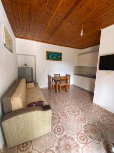 a living room with a couch and a table at Vila Demiraj Ksamil Sarande in Ksamil