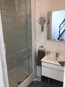 a bathroom with a glass shower and a sink at jolie studio 25 in Arras