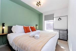 a bedroom with a bed with orange and white pillows at Spacious 3BR Durham Home Contractor Friendly in Durham