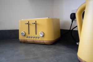 a yellow toaster sitting on top of a counter at Stylish Durham 3-Bed Comfort Long Stays in Spennymoor