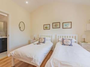 two twin beds in a room with white walls at 2 Bed in Winchester oc-77384 in Owslebury