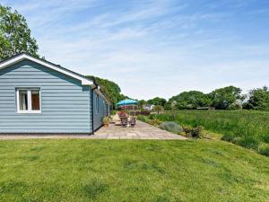 a woman sitting on a patio next to a house at 2 Bed in Winchester oc-77384 in Owslebury