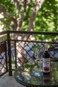 a bottle of wine and a wine glass on a table at Aureline Hill in Baku