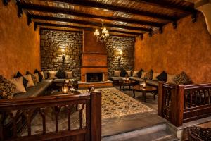 a living room with a couch and a fireplace at Hotel Doupiani House in Kalabaka
