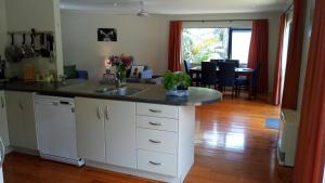 a kitchen with a sink and a counter top at Sea La Vie in the Bays in Auckland