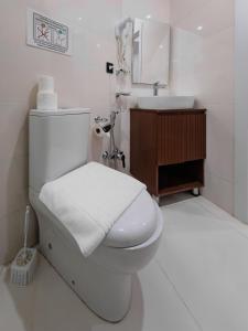a white bathroom with a toilet and a sink at Aureline Hill in Baku +28 photos