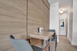 a dining room with a wooden table and chairs at King Suite at Ocean Blvd in Fort Lauderdale