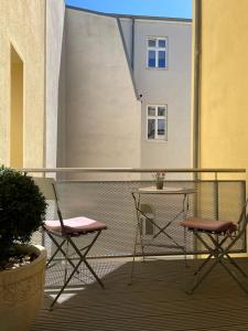 two chairs and a table on a balcony at FeWo Schweriner Altstadt in Schwerin