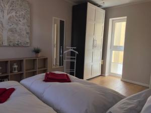 a bedroom with two beds and a large window at FeWo Schweriner Altstadt in Schwerin