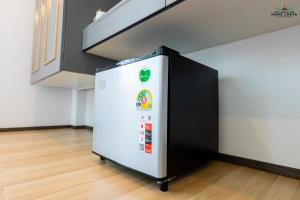 a white refrigerator in a room with a staircase at Ck Home Lanta in Phra Ae beach