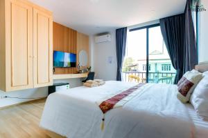 a bedroom with a large bed with a large window at Ck Home Lanta in Phra Ae beach