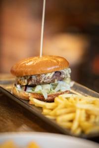 a hamburger and french fries on a tray at The Belfry, Littldean in Little Dean +8 photos