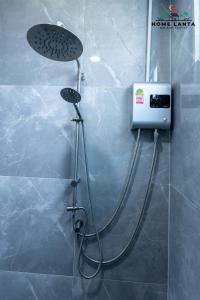 a shower in a bathroom with a shower head at Ck Home Lanta in Phra Ae beach +126 photos
