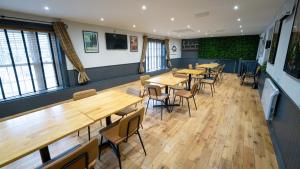 a row of tables and chairs in a restaurant at The Belfry, Littldean in Little Dean