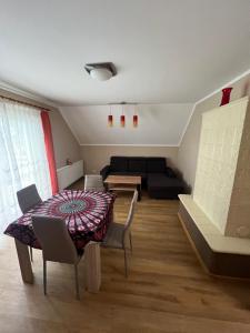 a living room with a table and a couch at Holiday house EWA in Meszna Opacka