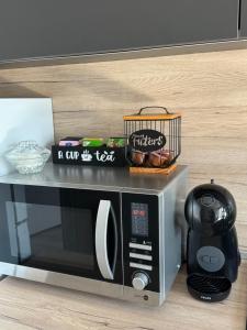 a microwave sitting on a counter next to a table at Aneva home in Ruse +14 photos