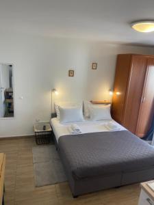 a bedroom with a large bed with white pillows at Apartmani Luky in Karlobag