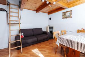 a living room with a couch and a ladder at Farm ,zidanica ,JOLI in Gorica pri Slivnici
