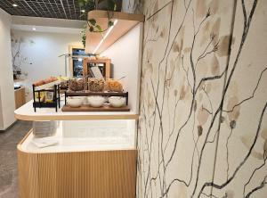 a shelf with bowls and other items on a wall at Hotel Campion CityLife in Milan