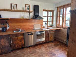 a kitchen with a sink and a stove top oven at Haus Tersteegen in Oberbrombach
