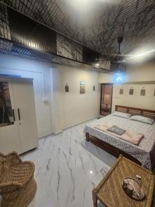 a large room with a bed and a couch at Richard's Homestay -Classy AC Rooms in Thiruvalla