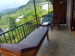 a balcony with a bench and a view of a mountain at SEENBEST Ella in Ella