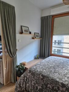 a bedroom with a bed and a window at Villa Sévigné in Nantes