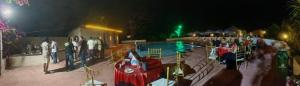 a group of people standing around a playground at night at The Kiran's Resort Pench in Khawāsa