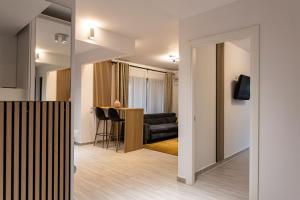 a living room with a couch and a table at Modern 2BR Balcony View Pipera in Voluntari