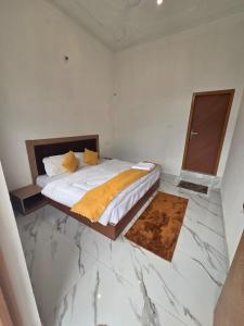 a bedroom with a bed and a marble floor at Deep Heritage Hotel & Restaurant in Phata