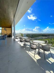 a patio with tables and chairs and a view at Nyali Evoque - BriSta Stays in Mombasa