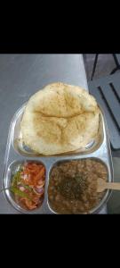 a tray of food with a pita bread and dips at The Mount lakes in Bhīm Tāl