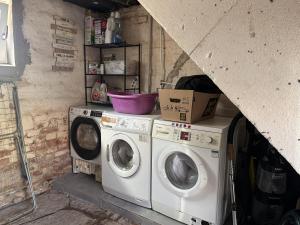 a laundry room with two washer and dryer at Am kleinen Storchennest in Ummendorf