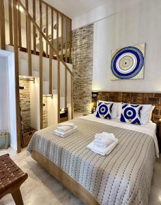 a bedroom with a large bed with two towels on it at Avra Guesthouse in Limenas