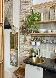 a kitchen with a sink and a mirror at Avra Guesthouse in Limenas +86 photos