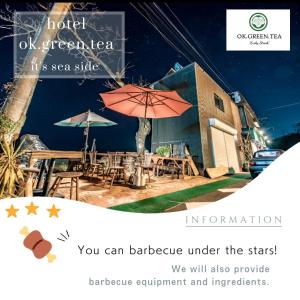 a restaurant with tables and umbrellas in front of a building at HOTEL OK GREEN TEA -Condo with ocean view- in Sonogi