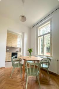 a dining room with a table and four chairs at Elbe Stay Roudnice in Roudnice nad Labem