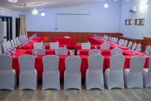 a conference room with red tables and white chairs at Kambiri Beach by Serendib in Senga +92 photos