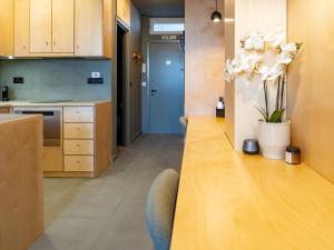 a kitchen with a long wooden table and a blue door at Downtown photographer's studio 2 in Korinthos +10 photos