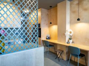 a dining room with a wooden table and chairs at Downtown photographer's studio 2 in Korinthos