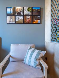 a couch with a pillow in a room with windows at Downtown photographer's studio 2 in Korinthos