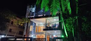 a lit up building with a balcony at night at Pibo Homestay in Port Blair