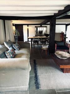 a living room with a couch and a table at Cottage in the Hambleden Valley in Henley on Thames