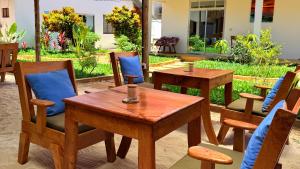 a group of tables and chairs in a patio at The 5th Element Boutique Hotel in Paje
