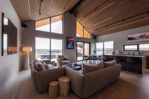a living room with a couch and a table at Modern Aurora Retreat in Selfoss
